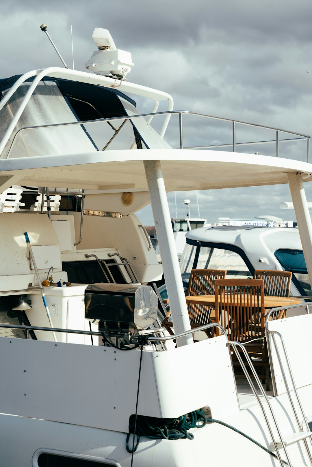 a-white-boat-is-docked-in-the-water-bclhfgnwwv0