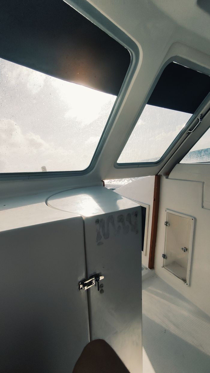 Bright capture of yacht cabin interior with sun streaming through the windows.
